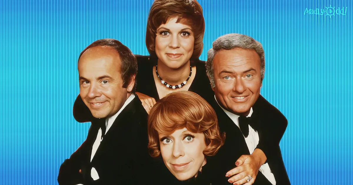 A group of four people in formal attire against a blue background, smiling.