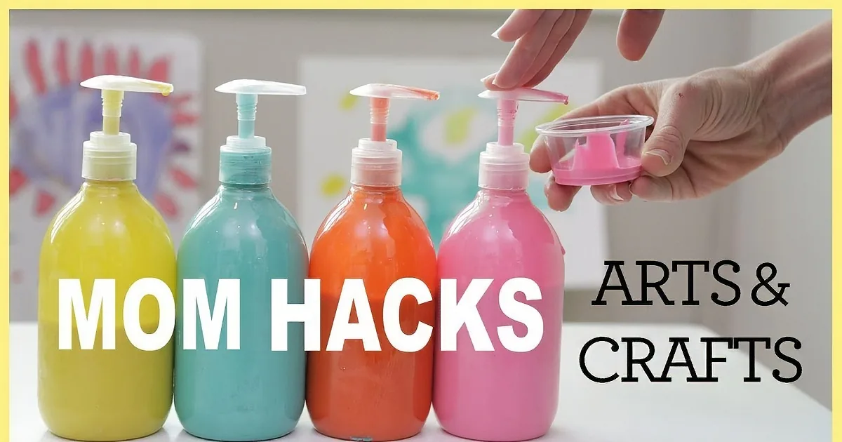 Colorful paint bottles with pump tops and a hand holding a small cup with a pink funnel.