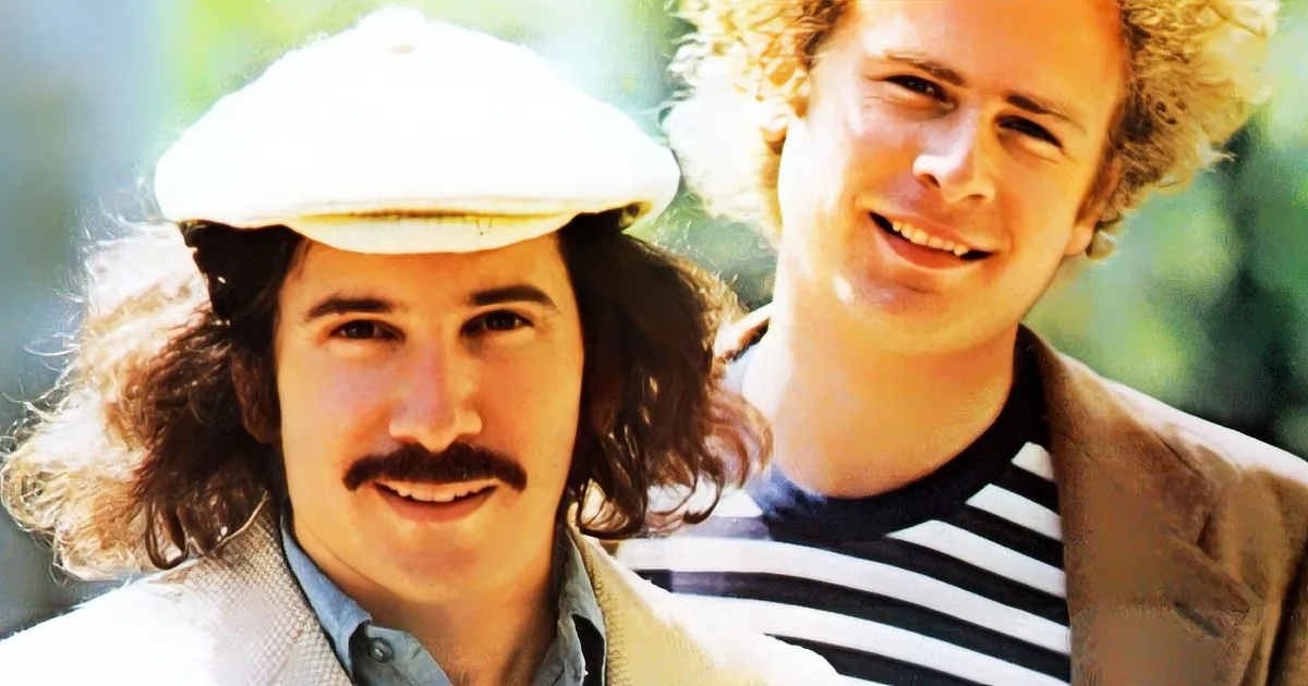 Two individuals with curly hair, one wearing a white cap, smiling outdoors.