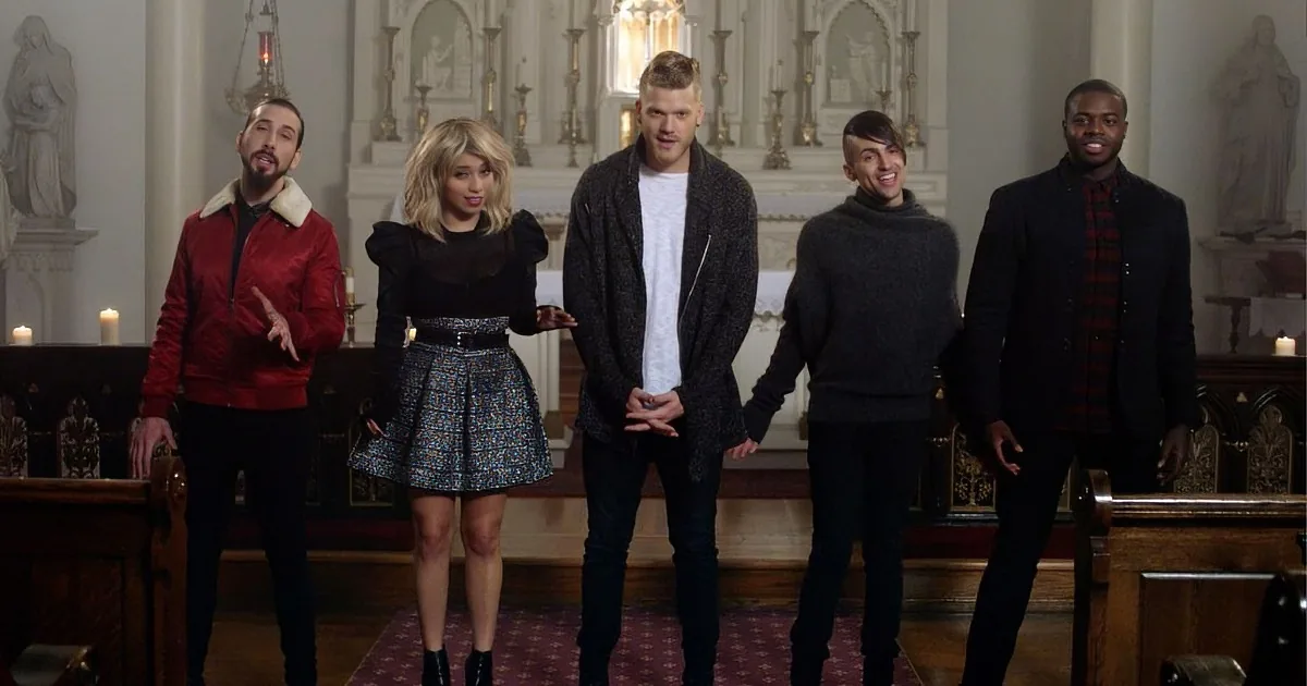 A group of five people stands in a church, dressed in stylish, casual outfits, with a mix of colors and textures.
