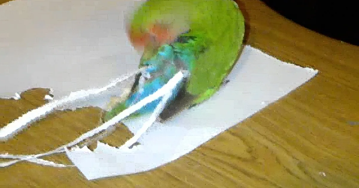 A green parrot with blue and red accents is perched on a piece of torn paper, holding a string in its beak.