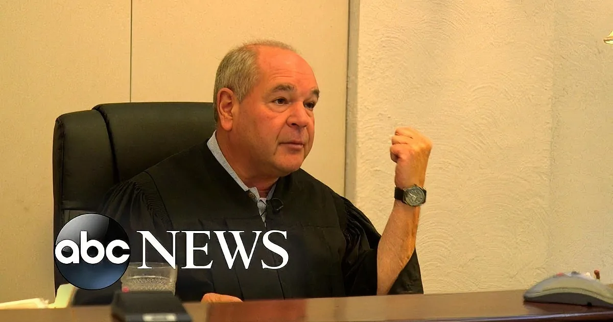A man in a judge's robe sits at a desk, raising his fist, with ABC News logo in the foreground.