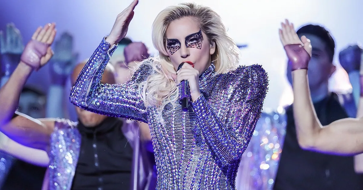Lady Gaga performs on a stage with smoke and lights at Super Bowl LI.