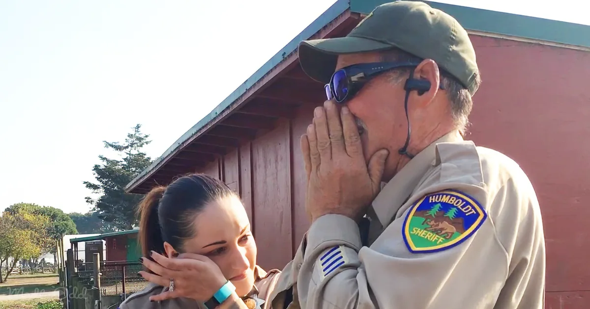 A man in a Humboldt Sheriff uniform covers his mouth, while a woman in a similar uniform looks on with her hand near her...