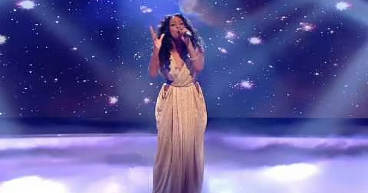 A woman in a flowing dress sings on stage against a starry, ethereal backdrop.