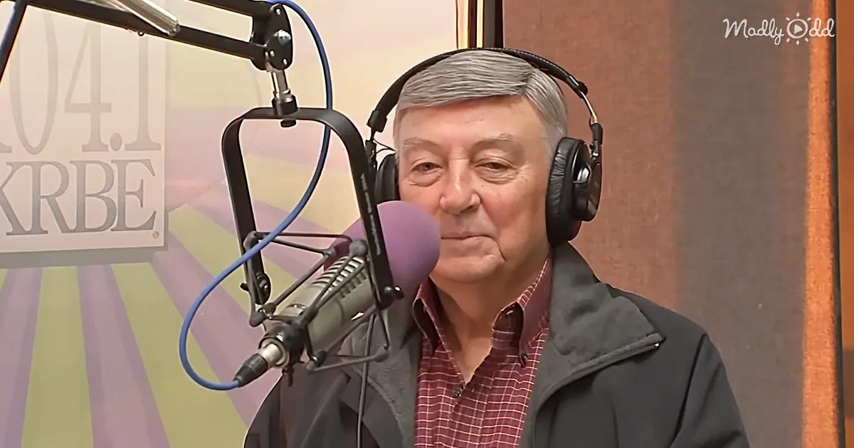 An older man wearing headphones speaks into a microphone in a radio studio setting.