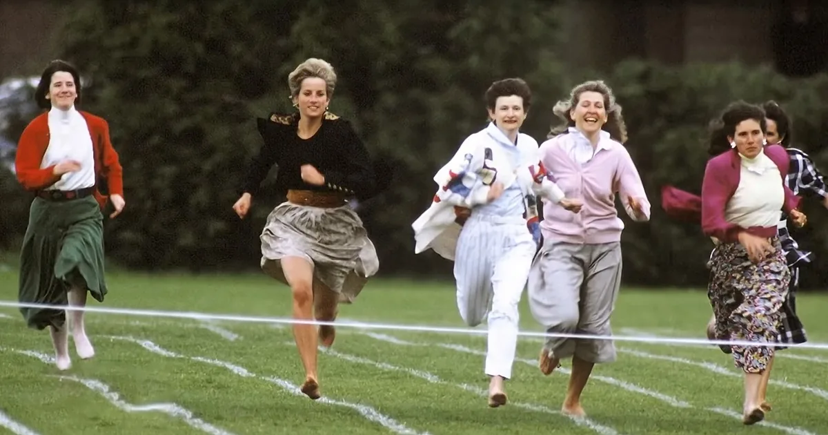 Princess Diana leads a group of women in a race on a grassy field.