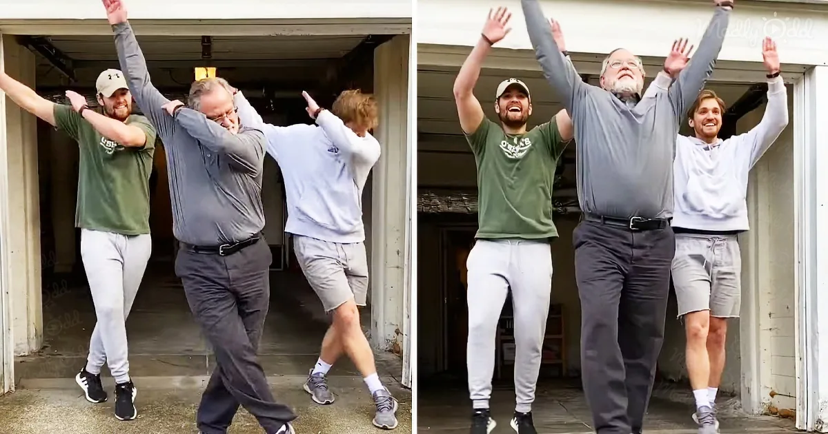 Three individuals, including an older man, are dancing joyfully with arms raised in a garage setting.