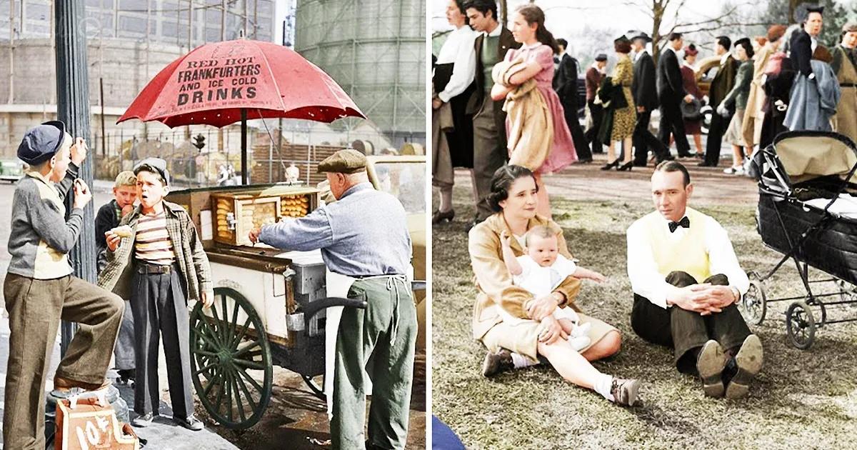 A street vendor sells hot dogs under a red umbrella, while a family sits on the grass with a baby and a pram.