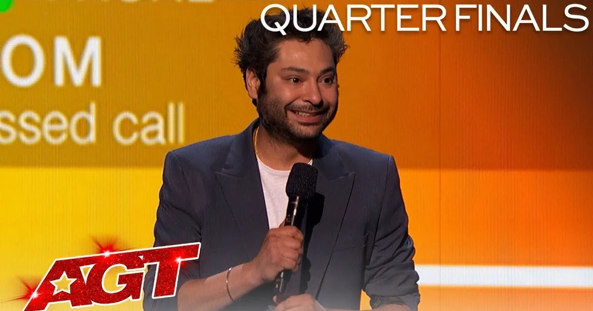 A man in a suit holds a microphone, gesturing with his other hand, with "MOM Missed call" on the screen behind him.