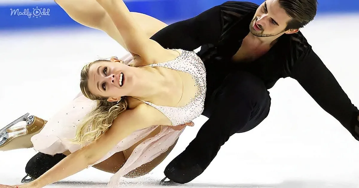 A figure skating couple performs a dramatic pose on the ice, showcasing their skill and artistry.