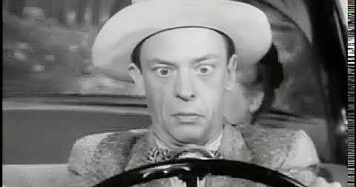 A man in a cowboy hat and suit with a surprised expression, sitting in a vehicle.