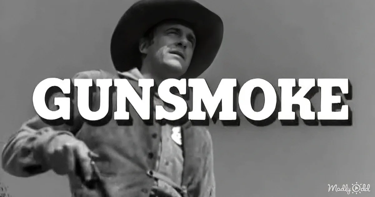 A cowboy in a wide-brimmed hat and jacket stands against a gray sky, with "GUNSMOKE" prominently displayed in bold white...