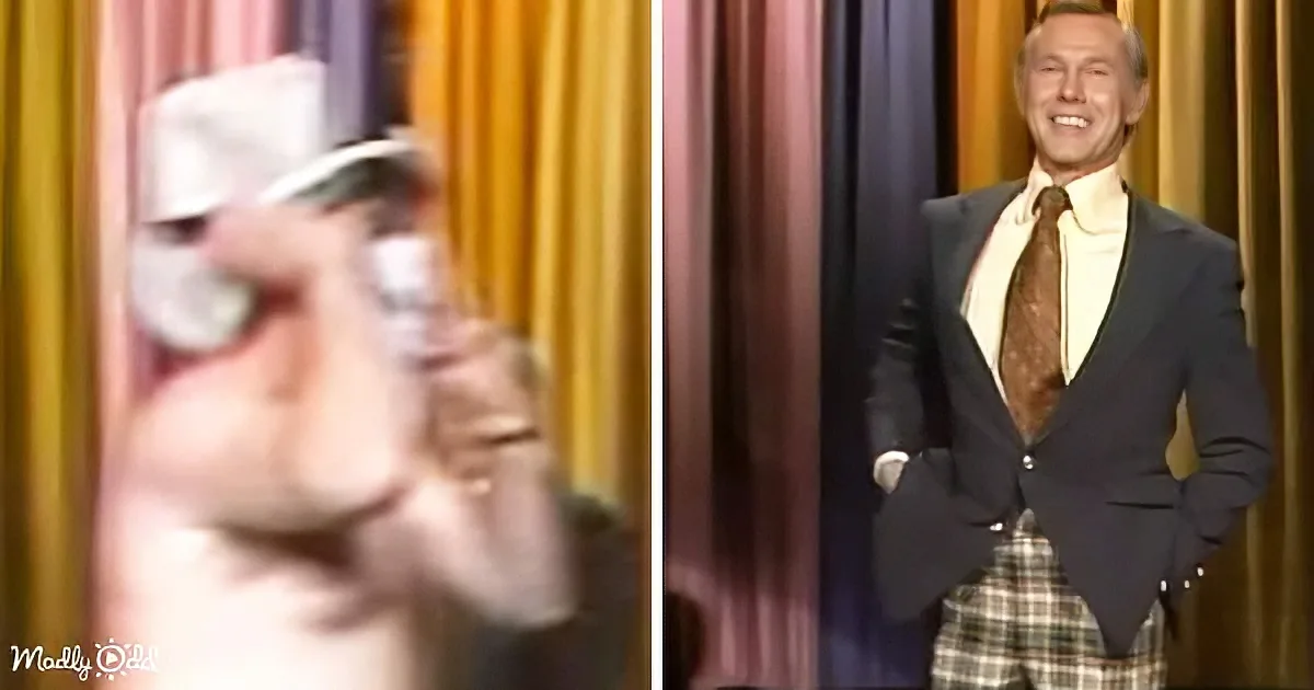 A man in a suit and tie stands confidently on stage, smiling, with a blurred close-up of his face on the left.