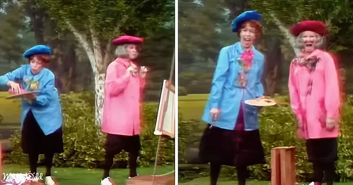 Two women in colorful outfits, one in blue and the other in pink, are standing outdoors, seemingly engaged in a playful...