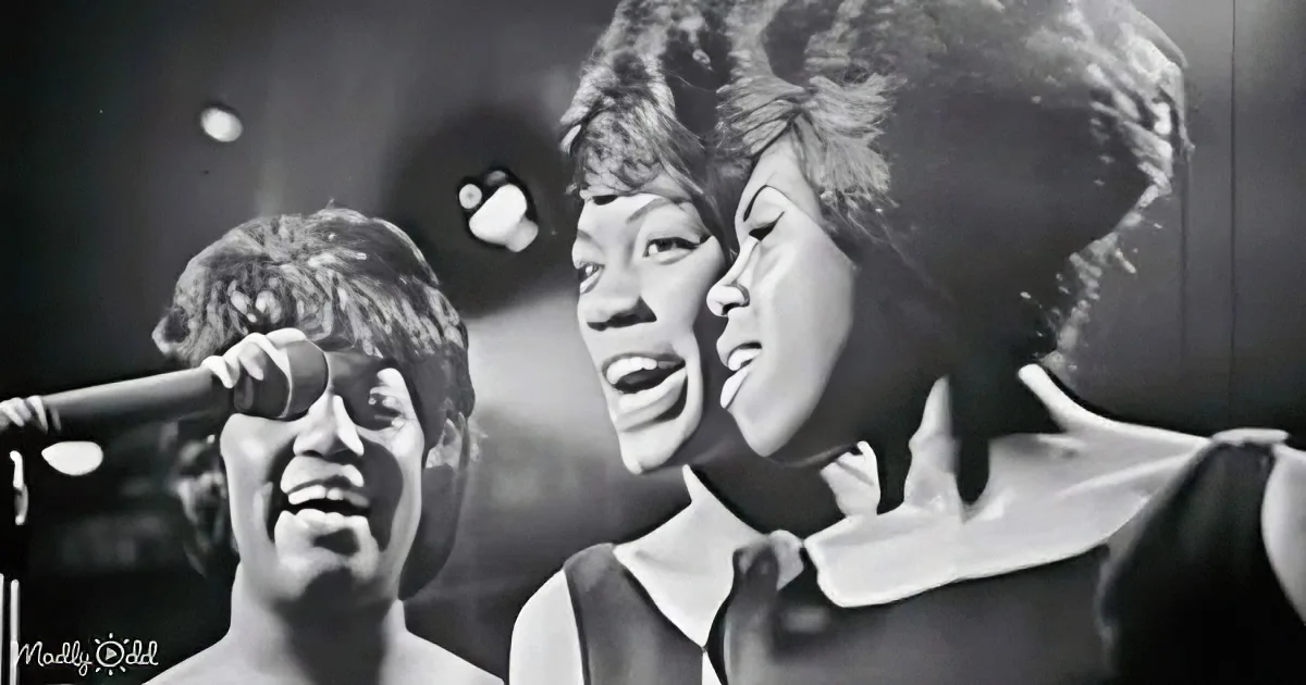 A black-and-white image captures three individuals singing passionately, with one prominently in the foreground.