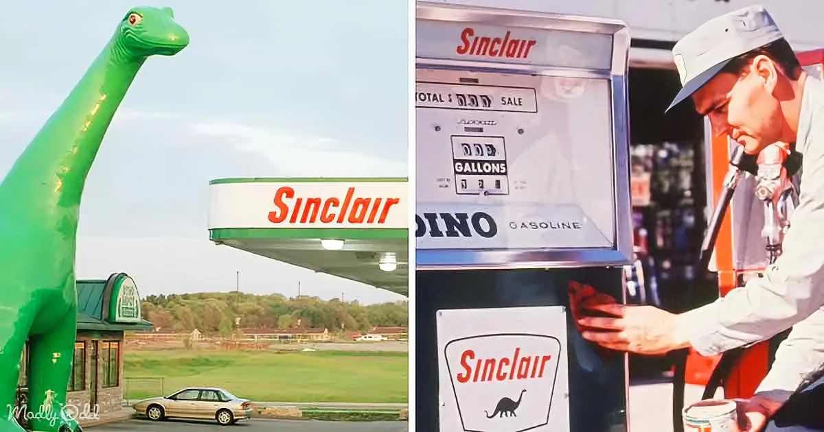 A green inflatable dinosaur stands beside a Sinclair gas station, while a man fills up a car at a vintage gas pump.