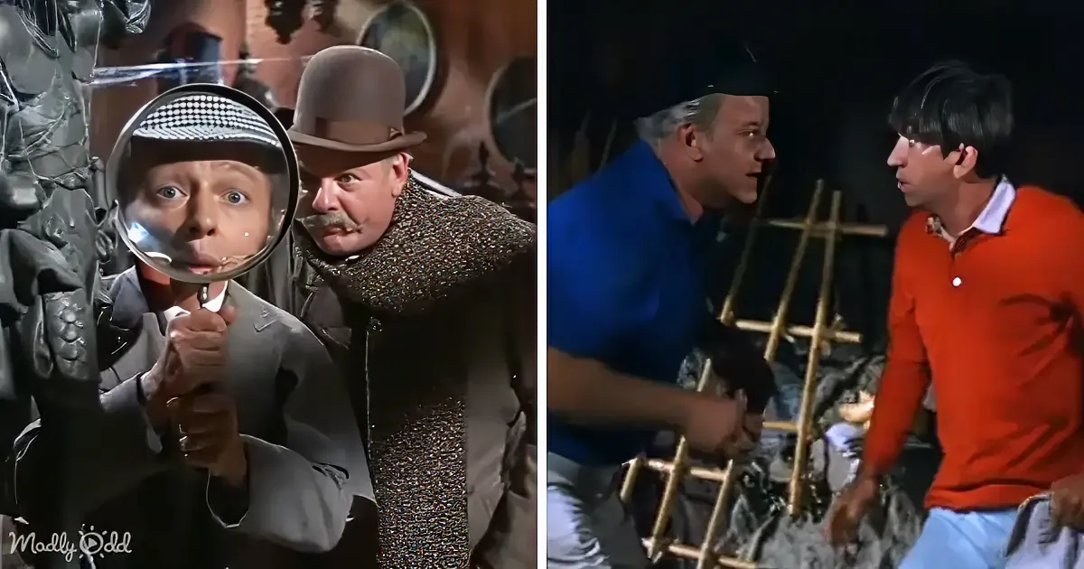 A man in a suit examines himself in a mirror, while another man in a hat looks on, and a third man in a blue shirt and...