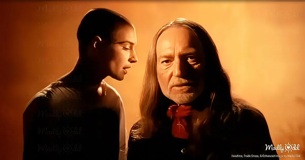 A man with long hair and a red bow tie stands beside another man in a dimly lit, warm-toned environment.