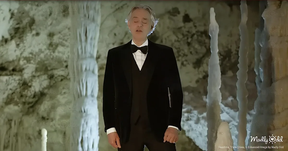 A man in a tuxedo stands with eyes closed in a snowy, icy environment.