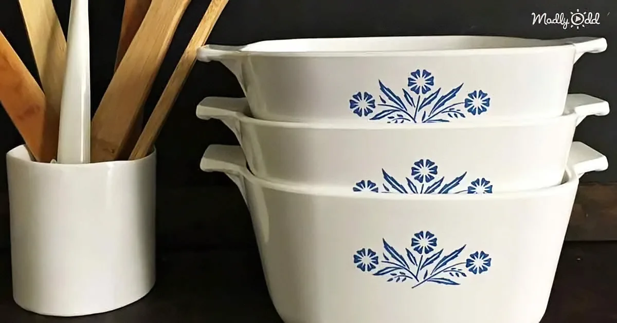 Stacked white bowls with blue floral patterns, wooden spoons in a white holder.