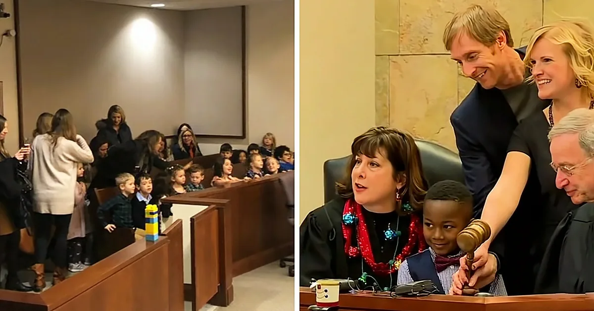 A judge is holding a gavel while a family stands behind her in a courtroom.