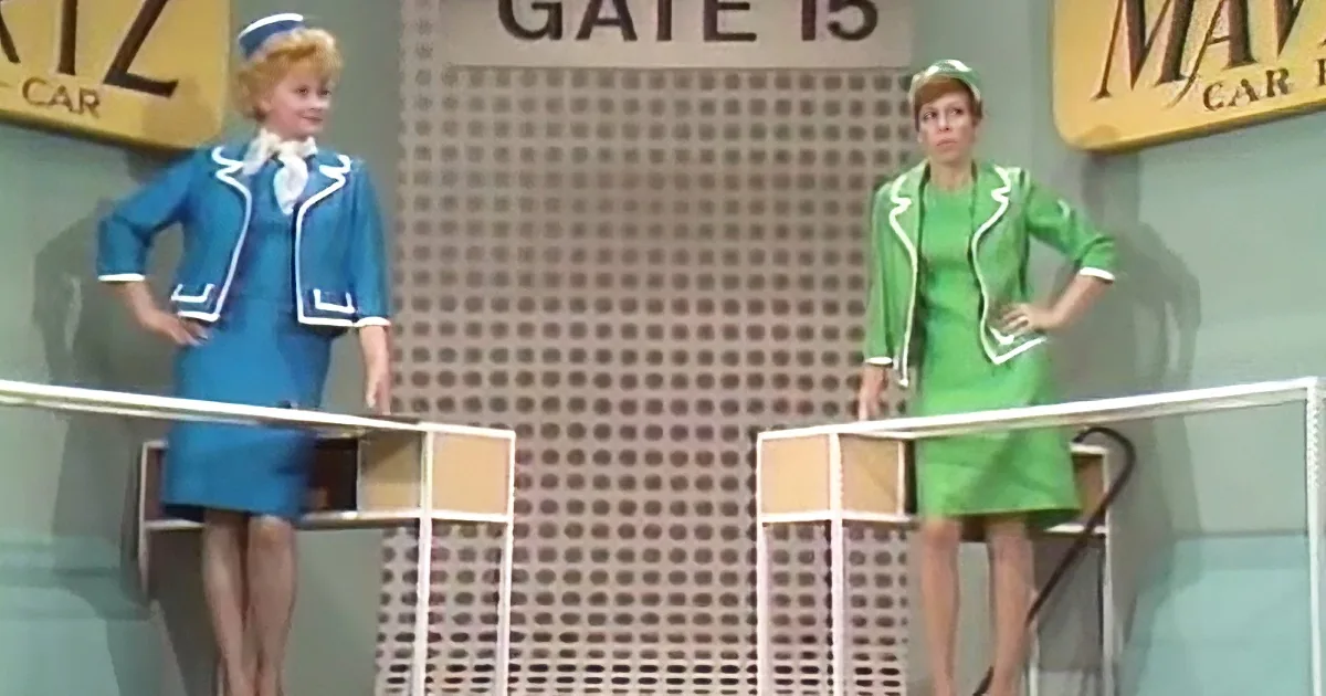 Two women in flight attendant uniforms stand on platforms, one in blue, the other in green, with "Gate 15" and "Mav Car"...