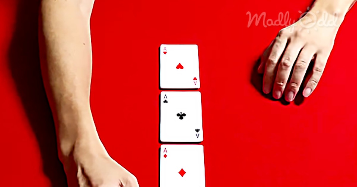 A hand holds a deck of cards, revealing a stop-motion video effect with four aces in a vertical line.